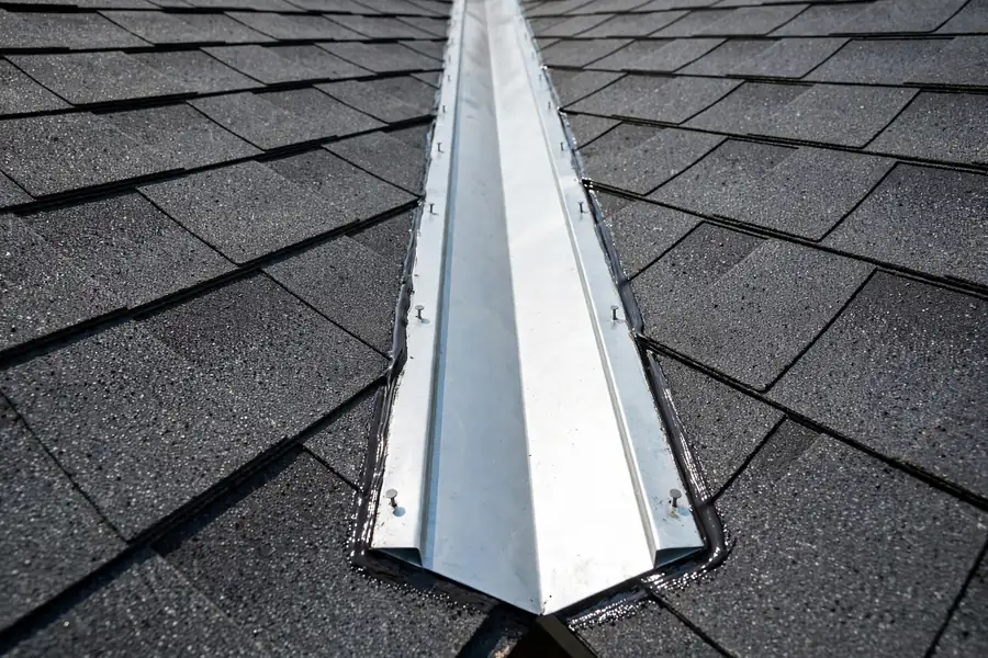 Roof valley with new flashing and pristine shingles after leak repair