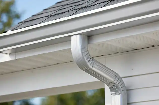 New seamless aluminum gutter and downspout installed on a home